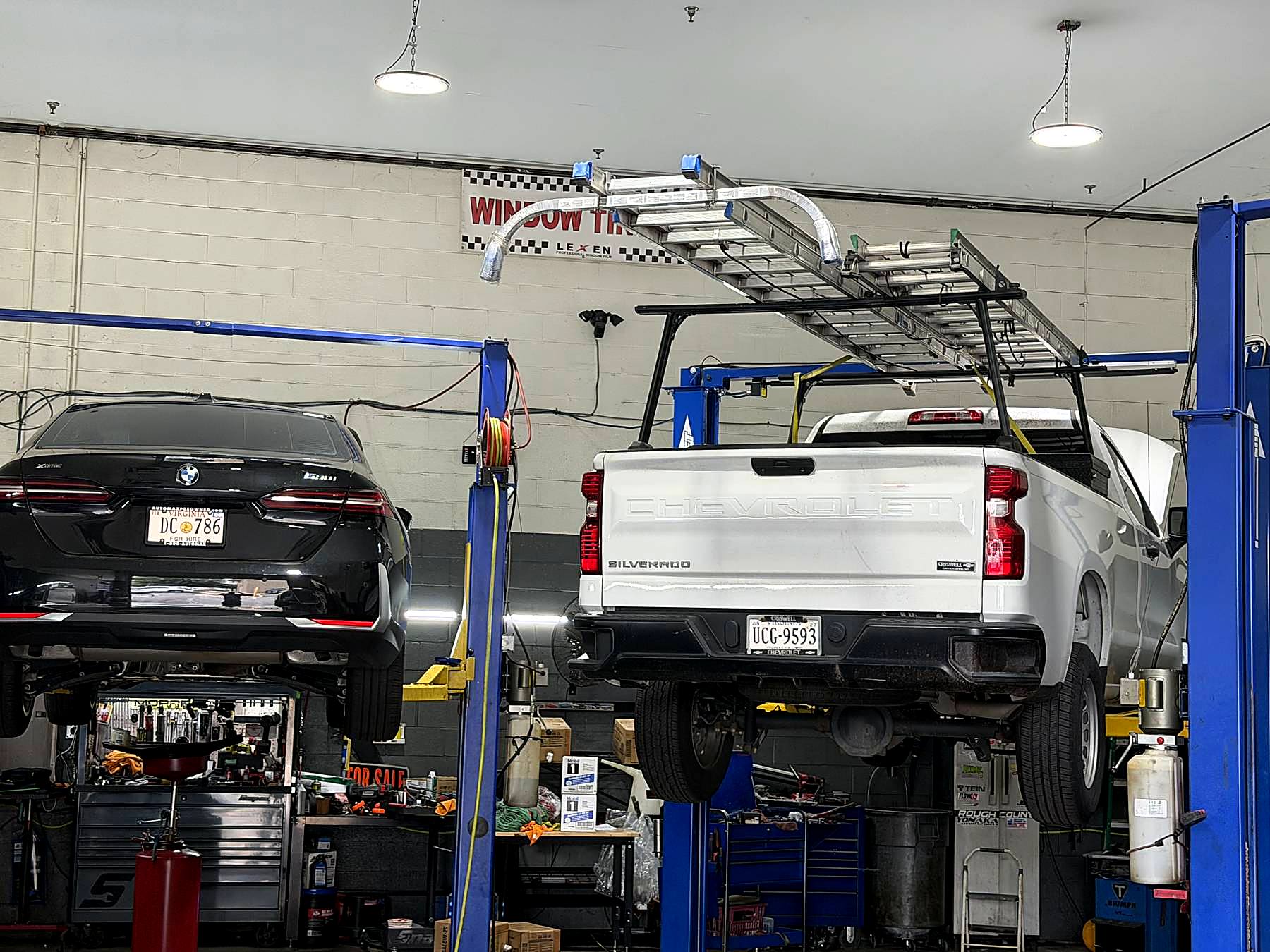 Inside the Triple R Auto Repair shop, vehicles up on lifts